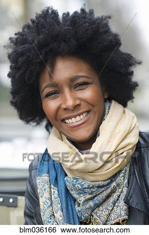 Stock Photograph - Smiling Black woman wearing scarves. Fotosearch