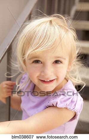 Smiling Caucasian girl sitting on steps View Large Photo Image Stock Photo - Smiling Caucasian girl sitting on steps. Fotosearch