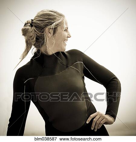 Smiling Caucasian woman wearing wetsuit View Large Photo Image Stock Photo - Smiling Caucasian woman wearing wetsuit. Fotosearch