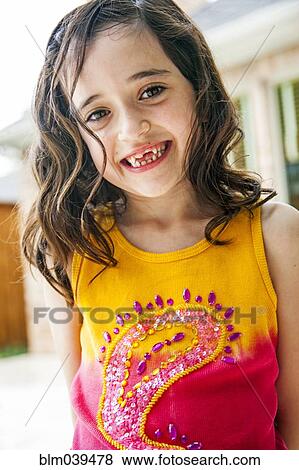 Stock Photo - Smiling girl displaying missing teeth. Fotosearch