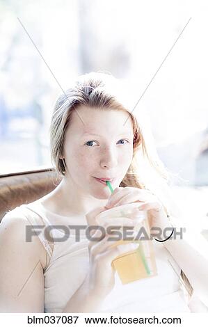 Smiling girl drinking iced tea View Large Photo Image Stock Photo - Smiling girl drinking iced tea. Fotosearch