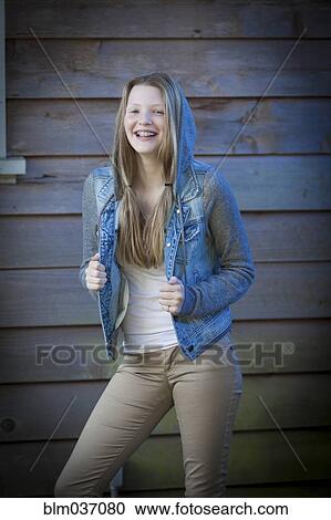 Smiling girl wearing denim jacket View Large Photo Image Stock Image - Smiling girl wearing denim jacket. Fotosearch