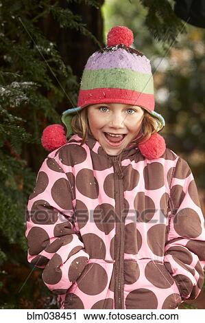 Smiling girl wearing hat and coat outdoors View Large Photo Image Stock Image - Smiling girl wearing hat and coat outdoors. Fotosearch