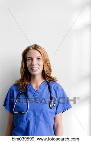 Stock Photo - Smiling nurse wearing stethoscope. Fotosearch