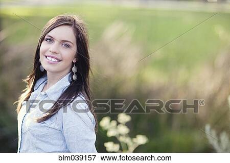 Stock Photo - Smiling woman in rural field. Fotosearch