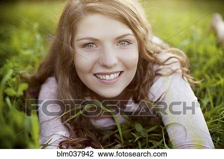 Smiling woman laying in rural field View Large Photo Image Stock Image - Smiling woman laying in rural field. Fotosearch