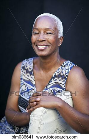 Smiling woman leaning on chair back View Large Photo Image Stock Image - Smiling woman leaning on chair back. Fotosearch