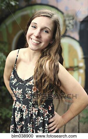 Smiling woman standing near graffiti wall View Large Photo Image Stock Image - Smiling woman standing near graffiti wall. Fotosearch