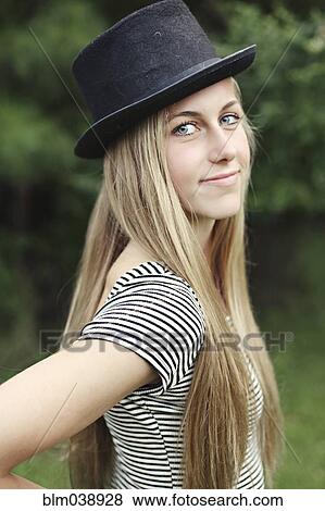Smiling woman wearing top hat outdoors View Large Photo Image Stock Photo - Smiling woman wearing top hat outdoors. Fotosearch