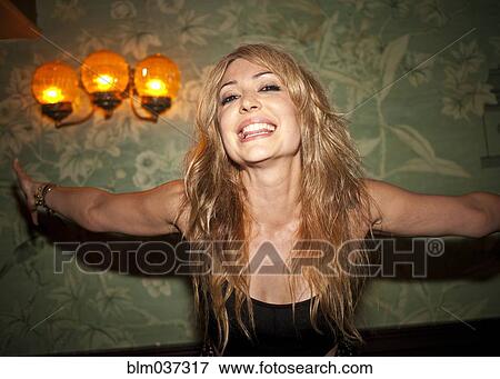 Stock Photo - Smiling woman with arms outstretched. Fotosearch