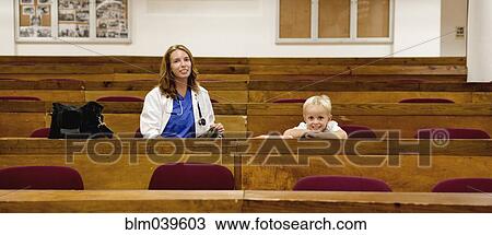 Stock Image - Student doctor and son sitting in college classroom. Fotosearch