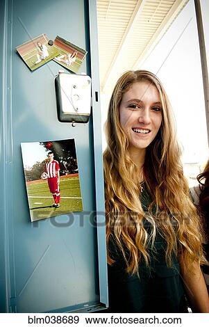 Stock Photo - Student standing at decorated locker at high school. Fotosearch