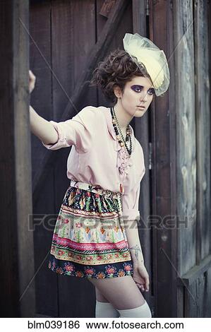 Stylish woman leaning on wooden gate View Large Photo Image Stock Photograph - Stylish woman leaning on wooden gate. Fotosearch