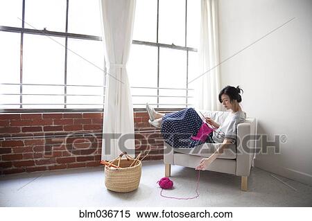 Taiwanese woman knitting in armchair near window View Large Photo Image Stock Photography - Taiwanese woman knitting in armchair near window. Fotosearch