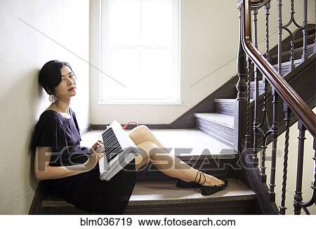 Stock Photo - Taiwanese woman playing keyboard on staircase. Fotosearch