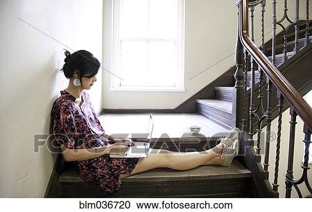 Taiwanese woman using laptop on staircase View Large Photo Image Stock Image - Taiwanese woman using laptop on staircase. Fotosearch