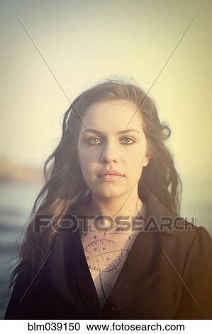 Tattooed woman standing on beach View Large Photo Image Stock Image - Tattooed woman standing on beach. Fotosearch