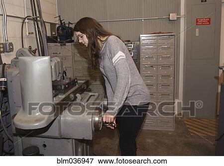 Technician operating machinery in warehouse View Large Photo Image Stock Photo - Technician operating machinery in warehouse. Fotosearch