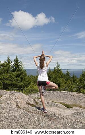 Teenage girl balancing on mountaintop View Large Photo Image Stock Photograph - Teenage girl balancing on mountaintop. Fotosearch