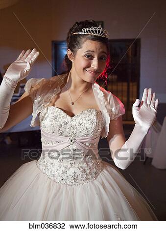 Stock Image - Teenage girl posing in quinceanera dress. Fotosearch
