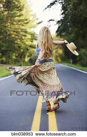 Teenage girl spinning on empty road View Large Photo Image Stock Image - Teenage girl spinning on empty road. Fotosearch