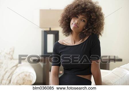 Teenage girl with curly hair indoors View Large Photo Image Stock Photography - Teenage girl with curly hair indoors. Fotosearch