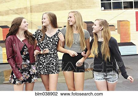 Stock Image - Teenage girls walking outdoors. Fotosearch