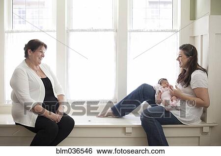 Stock Photograph - Three generations of Caucasian women in windowsill. Fotosearch