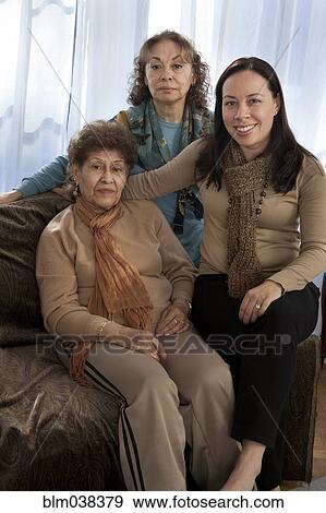Stock Photo - Three generations of women smiling on sofa. Fotosearch