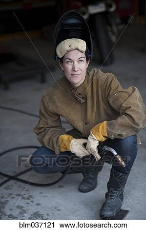 Welder crouching in workshop View Large Photo Image Stock Image - Welder crouching in workshop. Fotosearch