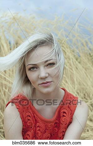 Wind blowing hair of Caucasian in tall grass View Large Photo Image Stock Photograph - Wind blowing hair of Caucasian in tall grass. Fotosearch
