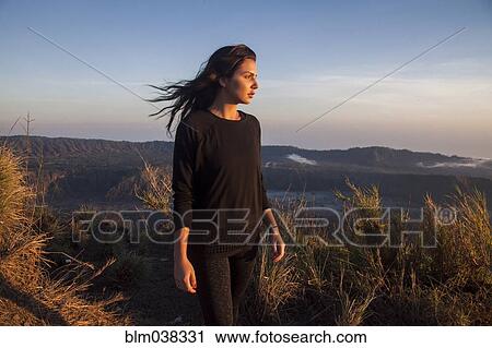 Woman admiring rural landscape from mountain path View Large Photo Image Stock Image - Woman admiring rural landscape from mountain path. Fotosearch