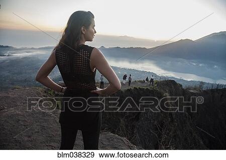 Woman admiring rural landscape from mountaintop View Large Photo Image Stock Photo - Woman admiring rural landscape from mountaintop. Fotosearch