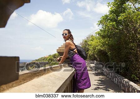 Woman admiring view from hillside path View Large Photo Image Stock Photo - Woman admiring view from hillside path. Fotosearch