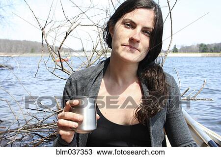 Woman drinking with metal cup in boat on lake View Large Photo Image Stock Image - Woman drinking with metal cup in boat on lake. Fotosearch