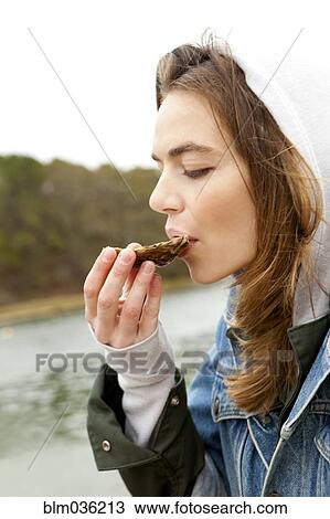 Woman eating fresh oyster at lake View Large Photo Image Stock Image - Woman eating fresh oyster at lake. Fotosearch