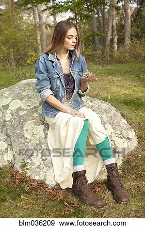 Woman examining plants in forest View Large Photo Image Stock Photo - Woman examining plants in forest. Fotosearch