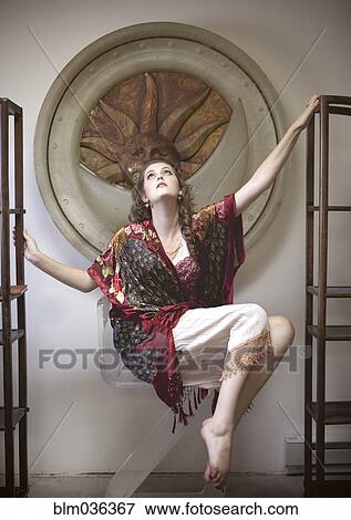Woman floating between empty bookshelves in ornate room View Large Photo Image Stock Photo - Woman floating between empty bookshelves in ornate room. Fotosearch