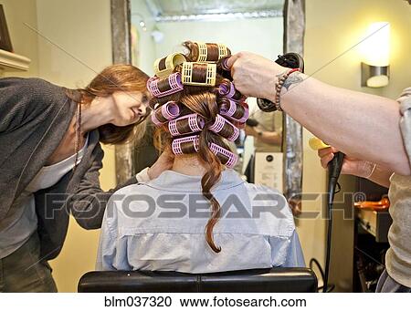 Woman having hair styled in salon View Large Photo Image Stock Image - Woman having hair styled in salon. Fotosearch
