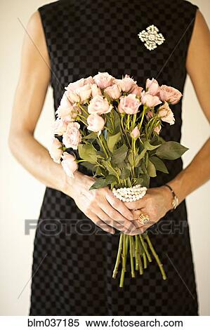 Woman holding bouquet of flowers View Large Photo Image Stock Photography - Woman holding bouquet of flowers. Fotosearch