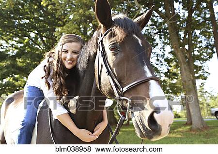 Woman hugging horse in rural field View Large Photo Image Stock Photo - Woman hugging horse in rural field. Fotosearch