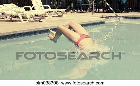 Woman in bikini diving backwards into swimming pool View Large Photo Image Stock Photo - Woman in bikini diving backwards into swimming pool. Fotosearch