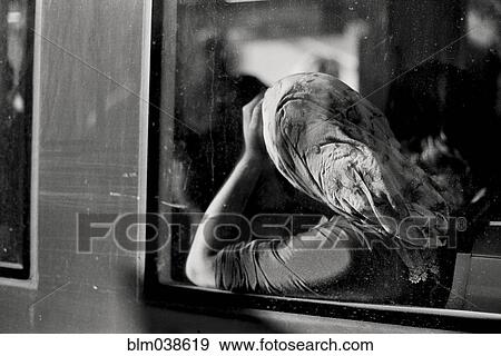 Stock Photo - Woman in headscarf riding in train. Fotosearch