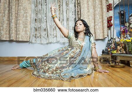 Stock Image - Woman posing in traditional dress and jewelry. Fotosearch