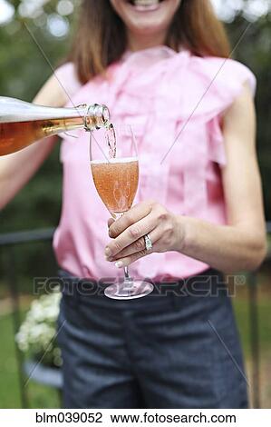 Woman pouring glass of rose wine View Large Photo Image Stock Image - Woman pouring glass of rose wine. Fotosearch