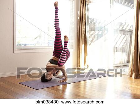 Woman practicing yoga in studio View Large Photo Image Stock Image - Woman practicing yoga in studio. Fotosearch