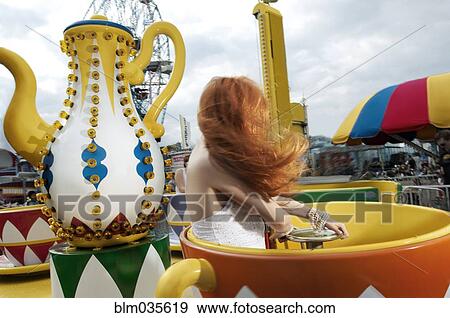 Stock Photo - Woman riding amusement park ride. Fotosearch