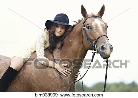 Stock Photo - Woman riding horse. Fotosearch