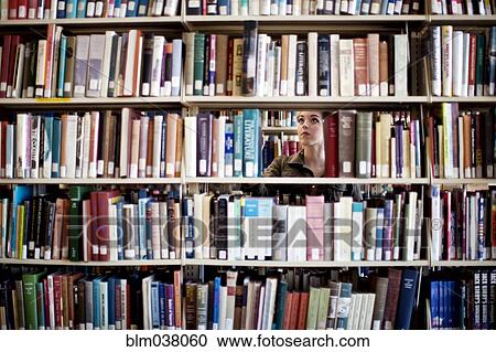 Woman searching for book in library View Large Photo Image Stock Image - Woman searching for book in library. Fotosearch
