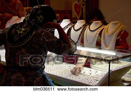 Woman shopping for jewelry in store View Large Photo Image Stock Image - Woman shopping for jewelry in store. Fotosearch